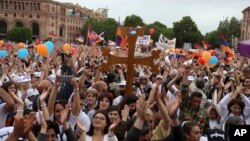 People cheer at the Republic Square in Yerevan, May 8, 2018. 