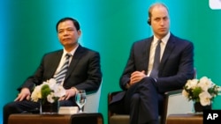 Vietnam's Minister of Agriculture Nguyen Xuan Cuong, left, and Britain's Prince William, Duke of Cambridge, right, listen to a speech at an international conference on illegal wildlife trade in Hanoi, Vietnam, Nov. 17, 2016.