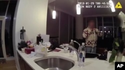 This Jan. 29, 2019 image made from police body cam video provided by the Chicago Police Department purports to show Jussie Smollett, with a white rope wrapped around his neck, talking with police officers in his apartment in Chicago.