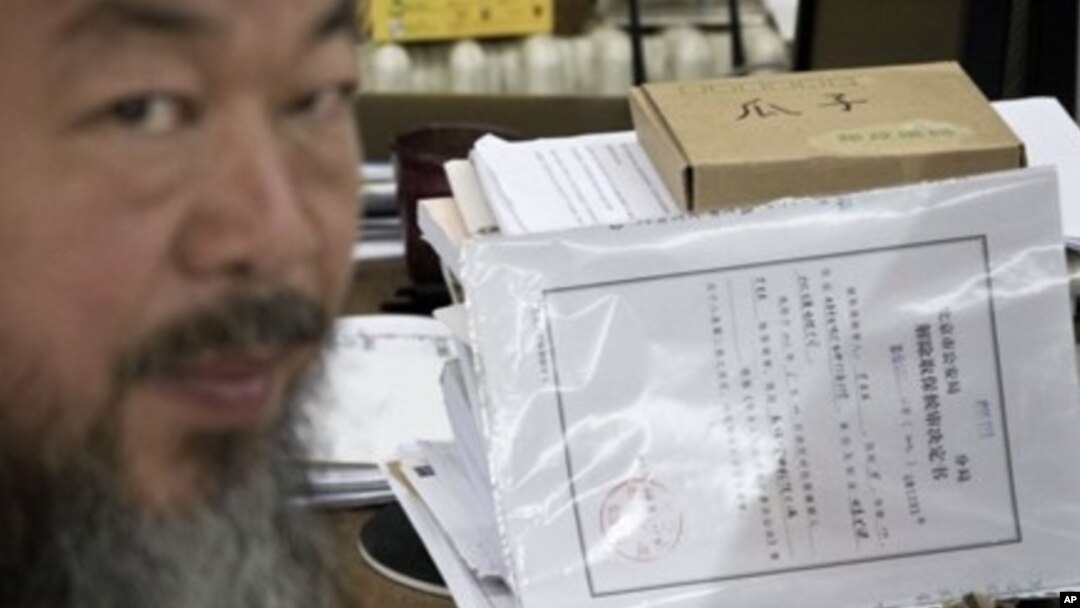 Artist Ai Weiwei with notice from city's Chaoyang District police that restrictions would expire Friday, Beijing, June 21, 2012.