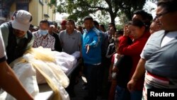 Relatives cry as the body of one of the Nepali mountaineering guides who was killed in Friday's avalanche on Mount Everest, is brought to Sherpa Monastery in Kathmandu, April 19, 2014.