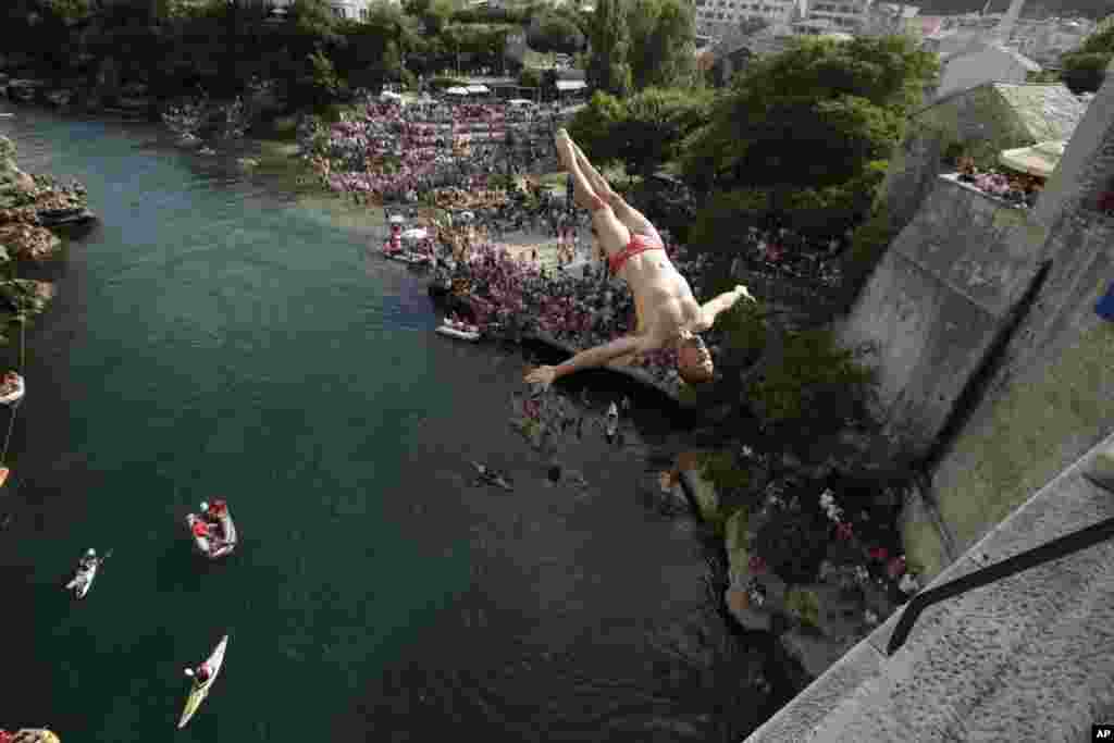 A diver jumps from the Old Mostar Bridge during the 452nd traditional annual high diving competition, in Mostar, Bosnia, 140 kilometers (87 miles) south of the capital Sarajevo.