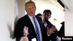 FILE - U.S. President Donald Trump speaks to reporters aboard Air Force One after visiting White Sulphur Springs, West Virginia, April 5, 2018.