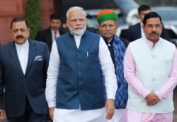 Indian Prime Minister Narendra Modi, center, with his cabinet colleagues arrive at the Parliament House on the opening day of the budget session in New Delhi, India, Jan. 31, 2020.