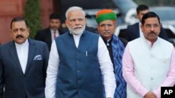 FILE - Indian Prime Minister Narendra Modi, center, with his cabinet colleagues arrive at the Parliament House on the opening day of the budget session in New Delhi, India, Jan. 31, 2020.