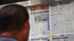 资料照片：一名男子在北京一报刊亭阅读《环球时报》关于中国人民解放军东部战区在台湾附近举行军事演习的报道。(2022年8月5日)