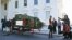 Michelle Obama with daughters Sasha and Malia and family dog Bo welcomes the arrival of the official White House Christmas tree, a 19-foot Fraser Fir from Jefferson, N.C., Nov. 23, 2012.