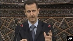 Syrian President Bashar al-Assad addresses the nation during a speech at the Parliament in Damascus, Syria, March 30, 2011