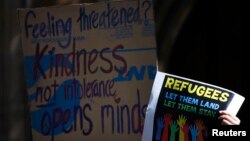 FILE - Protesters rally in central Sydney, Oct. 11, 2014, for refugees. A former Sudanese refugee has won one of Australia's highest civic awards. 