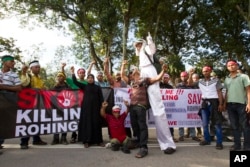 FILE - Myanmar ethnic Rohingya Muslims shout slogans during a protest against the persecution of Rohingya Muslims in Myanmar, in Kuala Lumpur, Malaysia, Dec. 4, 2016.