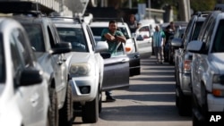 Motorists in the northbound lanes wait to enter the San Ysidro port of entry during a border security training drill by members of U.S. Customs and Border Protection Thursday, Jan. 10, 2019, in Tijuana, Mexico. (AP Photo/Gregory Bull)