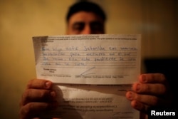 Melvin Garcia, 37, a deportee from the U.S. who was separated from his daughter Daylin Garcia, 12, at the McAllen entry point, shows a letter sent by U.S. Immigration and Customs Enforcement during an interview with Reuters in Choloma, Honduras, June 21, 2018. The letter reads "Your daughter is detained in a juvenile detention center in South Texas. She is pending an appointment in court."