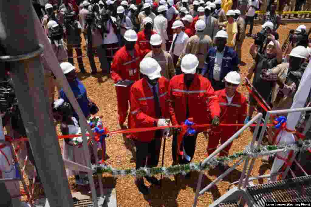 South Sudanese Oil Minister Stephen Dhieu Dau cuts the ribbon at Paloch oil field, where hydrocarbon production resumed on Sunday, May 5, 2013, after a 16-month break.