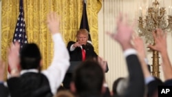 President Donald Trump calls on a reporter during a news conference in the East Room of the White House in Washington, Feb. 16, 2017.