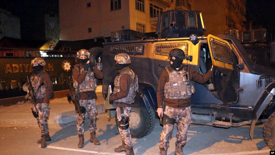 Turkish anti-terrorism police stand by their armoured vehicle during an operation to arrest people over alleged links to the Islamic State group, in Adiyaman, southeastern Turkey, early Sunday, Feb. 5, 2017. 