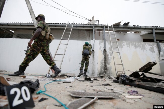Security personnel are seen at the site of an overnight gunbattle between troops and suspected Islamist militants, on the east coast of Sri Lanka, in Kalmunai, April 27, 2019.