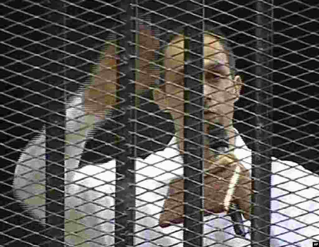 Video image taken from Egyptian State Television shows Hosni Mubarak's son Gamal speaking into a microphone in a cage in a Cairo courtroom. (AP Image)