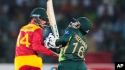 FILE: Zimbabwe's Sean Williams hits boundary as Pakistani wicketkeeper Mohammad Rizvan looks on during a match at the Gaddafi Stadium in Lahore, Pakistan, Sunday, May 24, 2015.