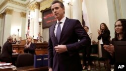 FILE - California Gov. Gavin Newsom receives applause after delivering his first state of the state address to a joint session of the legislature at the Capitol in Sacramento, Calif., Feb. 12, 2019. 