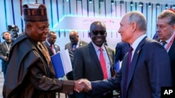 Wakil Presiden Republik Federal Nigeria Kashim Shettima, kiri, dan Presiden Rusia Vladimir Putin berjabat tangan setelah sesi pleno di KTT Afrika Rusia di St. Petersburg, Rusia, Jumat, 28 Juli 2023. (Mikhail Metzel/TASS Agen via AP)