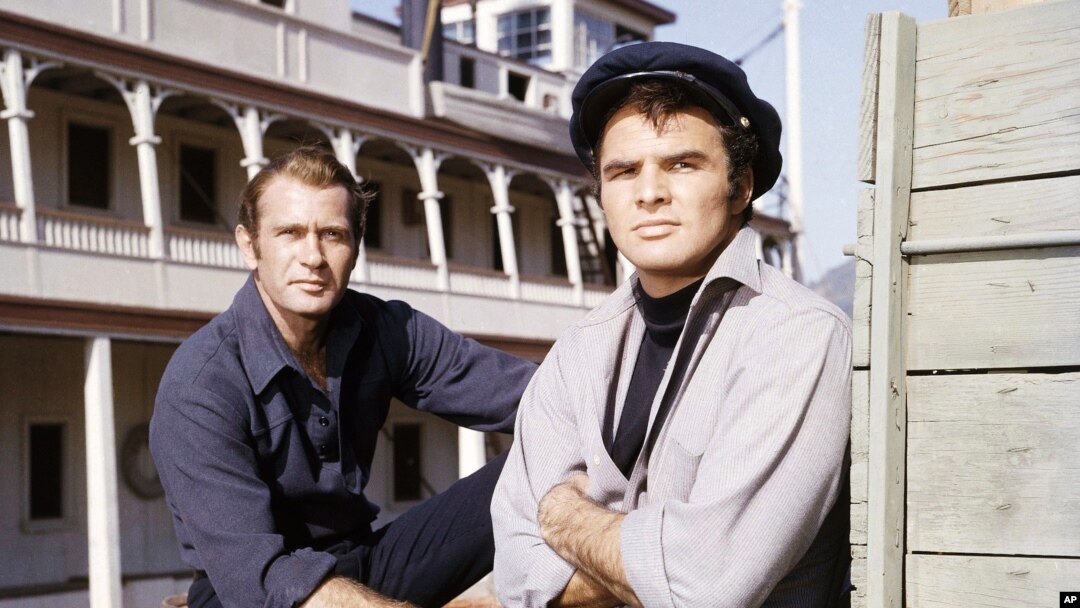 FILE - Actors Burt Reynolds and Darren McGavin are seen on the set of the TV program "Riverboat" on NBC, Aug. 18, 1959.