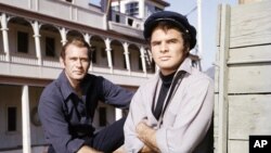 FILE - Actors Burt Reynolds and Darren McGavin are seen on the set of the TV program "Riverboat" on NBC, Aug. 18, 1959.