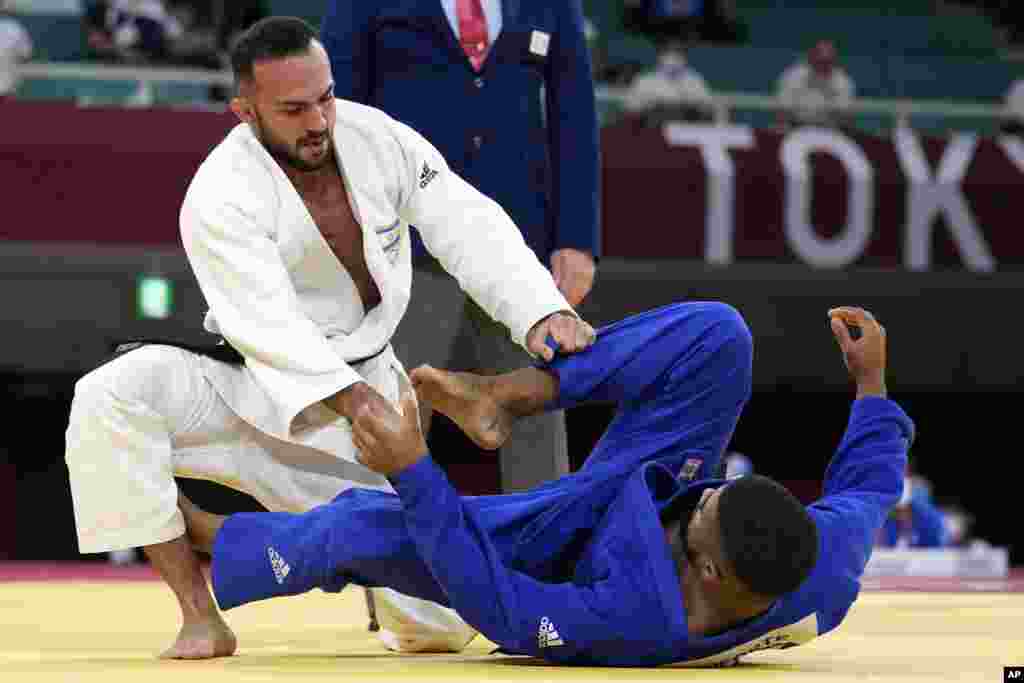 Baruch Shmailov of Israel, left, and Kevin Loforte of Mozambique compete during their men&#39;s -66kg round of 32 judo match at the 2020 Summer Olympics, Sunday, July 25, 2021, in Tokyo, Japan. (AP Photo/Vincent Thian)