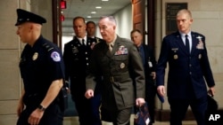 Joint Chiefs Chairman Gen. Joseph Dunford, center, walks to a classified briefing for members of the U.S. Senate on Iran, on Capitol Hill in Washington, May 21, 2019. 
