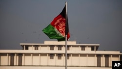 FILE - Afghanistan's flag is seen hoisted before the President House in Islamabad, Pakistan, Nov. 13, 2014, ahead of Afghan President Ashraf Ghani's first state visit to neighboring Pakistan.