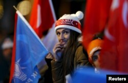 An AK Party supporter waits for the start of Turkey's Prime Minister Ahmet Davutoglu's speech in front of the party headquarters in Ankara, Turkey November 2, 2015.