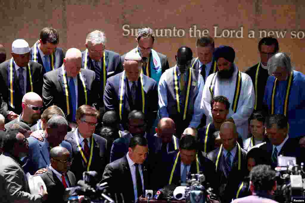 Interfaith leaders take part in a prayer vigil in a park following the multiple police shooting in Dallas, Texas, July 8, 2016.
