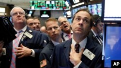 FILE - Traders are seen working on the floor of the New York Stock Exchange, Nov. 14, 2018.