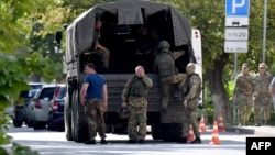 FILE - Russian servicemen get into a truck in Southern Russian city of Rostov-on-Don on Sept. 7, 2023, prior to Russia's local elections. 