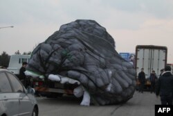 Cargo on an overloaded vehicle slumps off to the side after arriving from the Kaesong joint industrial zone, outside a military checkpoint in Paju on February 11, 2016.