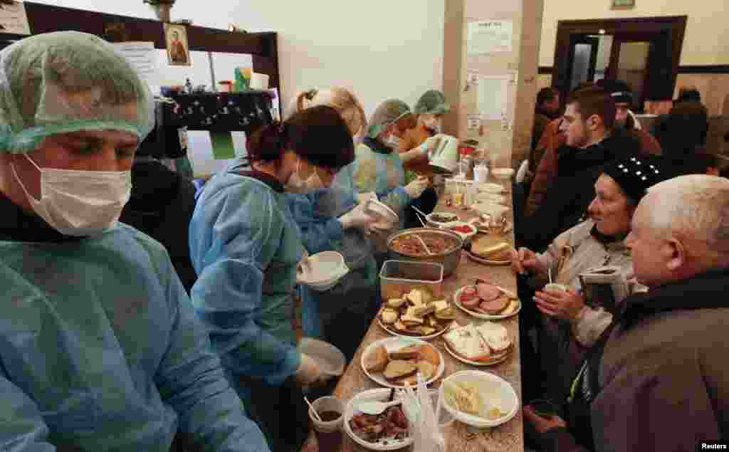 People pick up food inside the Kyiv City Council building which is occupied by pro-European integration protesters, Dec. 13, 2013. 