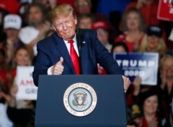 FILE - President Donald Trump gestures to the audience during a Keep America Great Rally in Tupelo, Mississippi, Nov. 1, 2019.