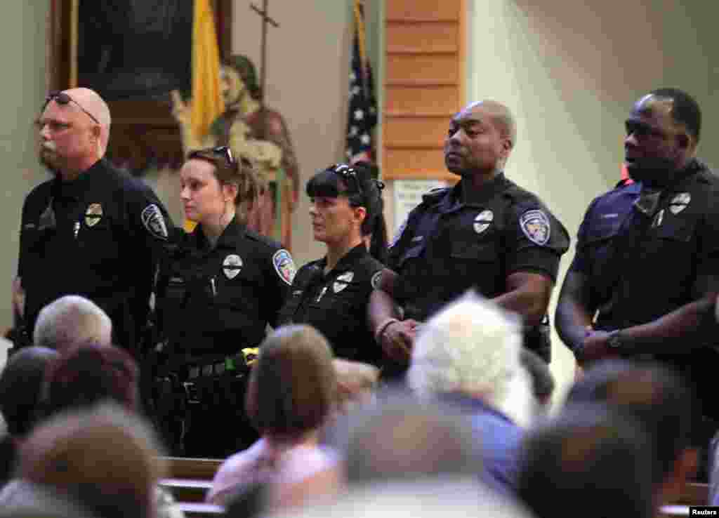 Police officers attend a church service after a fatal shooting of Baton Rouge policemen, at Saint John the Baptist Church in Zachary, Louisiana, July 17, 2016. 