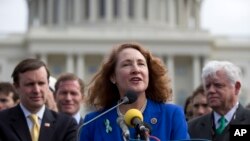 FILE - U.S. Representative Elizabeth Esty, D-Conn., center, speaks during a news conference on Capitol Hill in Washington, March 12, 2013. Esty's fellow Democrats are urging her to resign over accusation of workplace misconduct in her office.