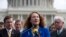 FILE - U.S. Representative Elizabeth Esty, D-Conn., center, speaks during a news conference on Capitol Hill in Washington, March 12, 2013. Esty's fellow Democrats are urging her to resign over accusation of workplace misconduct in her office.