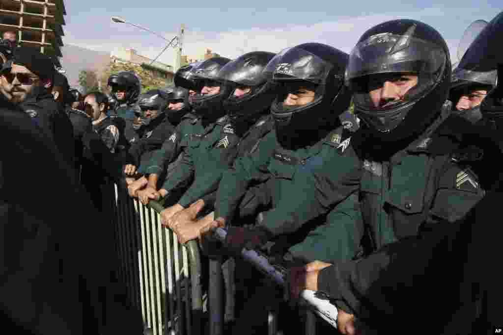 Iranian police officers protect the embassy of Saudi Arabia in Tehran during a gathering of protesters who blame the country for a deadly stampede on Thursday that killed more than 700 pilgrims, Sept. 27, 2015.