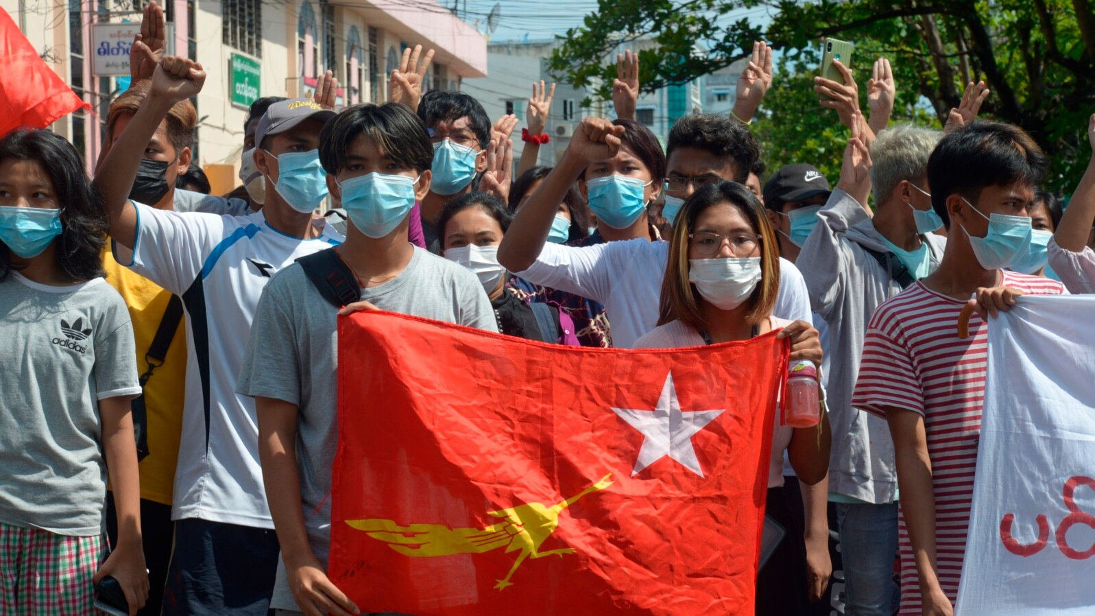 FILE - Protesters hold the flag of the National League for Democracy party of ousted Myanmar leader Aung San Suu Kyi at a rally against the military coup in Yangon, Myanmar, on May 9, 2021. The junta will execute five democracy activists on Sept. 24, 2024, a rights group says.