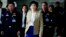Prime Minister Yingluck Shinawatra, center, leaves the Thai Air Force headquarters after a cabinet meeting in Bangkok, Thailand, Feb. 25, 2014.