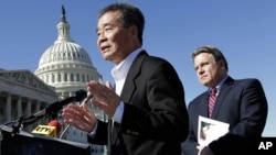 FILE - Rep. Chris Smith, R-N.J., right, listens as he and human rights activist Harry Wu, left, criticize the one-child rule in China, at the Capitol in Washington, Monday, March 7, 2011. 