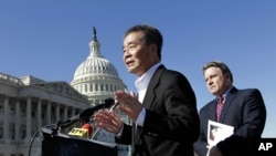 Rep. Chris Smith, R-N.J., right, listens as he and human rights activist Harry Wu, left, criticize the one-child rule in China, at the Capitol in Washington, Monday, March 7, 2011. 