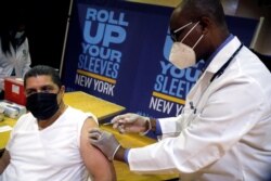 FILE - The Pfizer vaccine is given amid the coronavirus pandemic, in the Harlem section of Manhattan in New York City, New York, April 23, 2021.