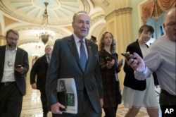 Senate Minority Leader Chuck Schumer, D-N.Y., is met by reporters as he arrives at the Capitol on the first morning of a partial government shutdown, in Washington, Dec. 22, 2018.