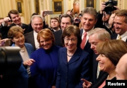Senators' Susan Collins (R-ME) addresses reporters with fellow Senators' Jeanne Shaheen (D-NH), Tim Kaine (D-VA), Heidi Heitkamp (D-ND), Joe Manchin (D-WV), Lindsey Graham (R-SC), Amy Klobuchar (D-MN) and Jeff Flake (R-AZ) after lawmakers struck a deal to reopen the federal government three days into a shutdown on Capitol Hill in Washington, Jan. 22, 2018.