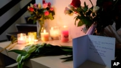Tributes are placed on a table in an apartment block in Rotterdam, Netherlands, on Dec. 14, 2018, where American student Sarah Papenheim lived. Papenheim, a 21-year-old psychology student at Erasmus University, was fatally stabbed at her home on Wednesday