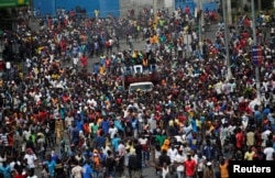 Demonstrators march during a protest to demand the resignation of Haitian president Jovenel Moise, in the streets of Port-au-Prince, Haiti, Oct. 11, 2019.