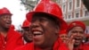 FILE - Julius Malema, center, leader of the Economic Freedom Fighters (EFF), arrives at Parliament wearing a hard hat and overall to show solidarity with coal mine workers, in Cape Town, South Africa, May 21, 2014.